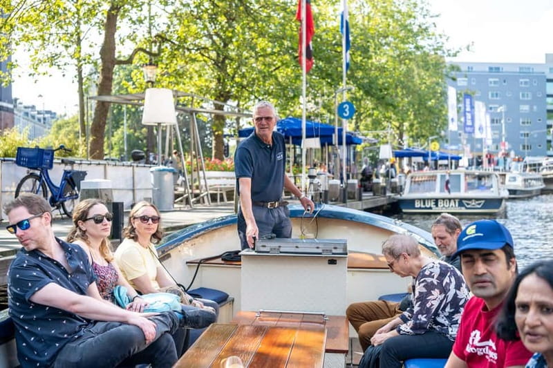 Amsterdam: 75 minute Open Boat Canal Cruise with Live Guide - A small open boat that gets you into Amsterdam’s tighter canal threads