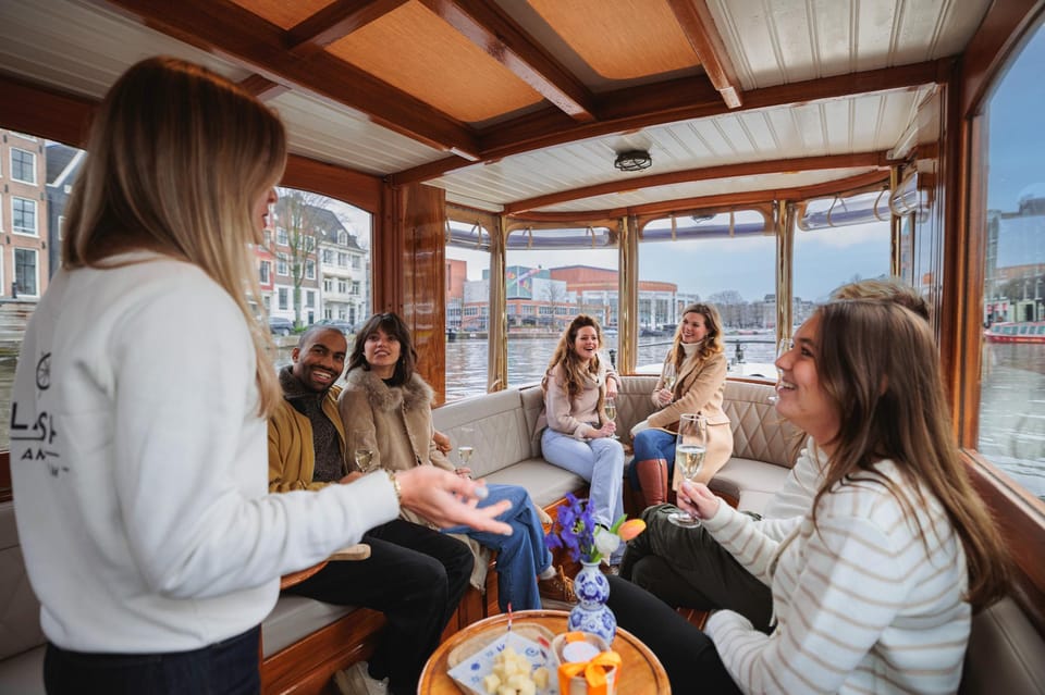 Amsterdam: Canal Cruise with Bubbles & Bites - Getting on Board: The Covered Boat Comfort (and One Important Step)