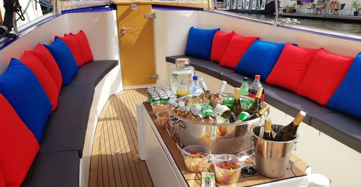 Amsterdam: Covered Canal Booze Cruise with Unlimited Drinks - The covered boat, the hosts, and how the drinks work