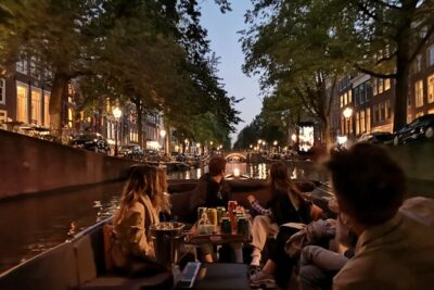 Amsterdam Evening Cruise in Small Group - The Amstel River segment: leaning houses, the Zuiderkerk area, and Munt Tower
