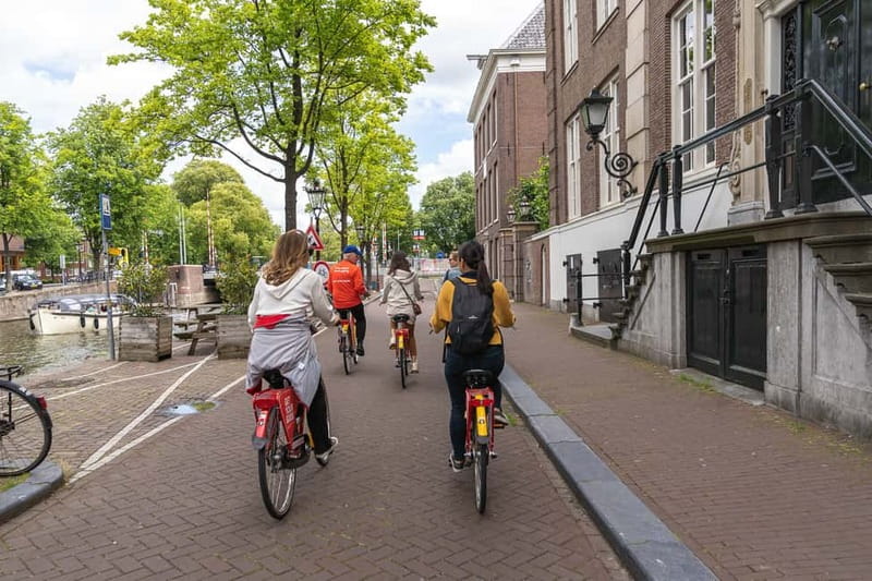 Amsterdam: Guided Bike Tour City Centre in EN/DE/FR/ES - Western Islands: drawbridges, old warehouses, and a different Amsterdam mood