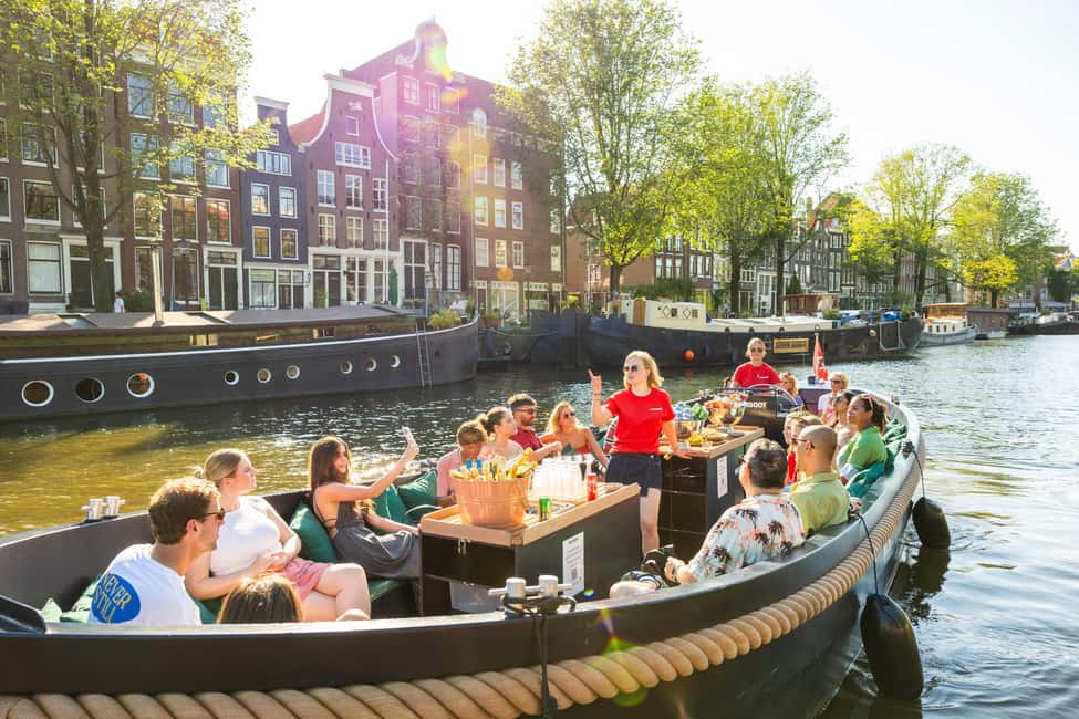 Amsterdam: Guided Open Boat Canal Cruise Including Drink - Entering Amsterdam by Water: Why an Open-Boat Cruise Works