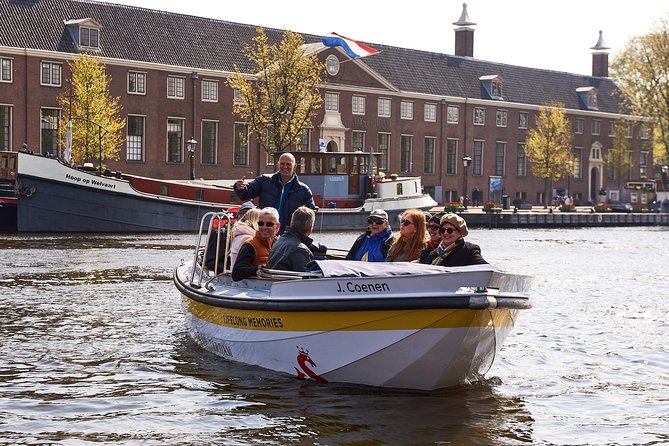 Amsterdam Open Boat Tour with Local Guide - Your one-hour route: classic canals plus two unforgettable bridge moments