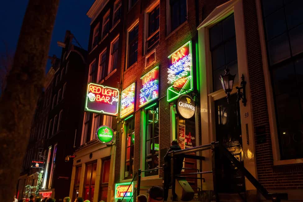 Amsterdam: Red Light District Tour in German/English/Italian - Condomerie, Oude Kerk, and Warmoestraat: Amsterdam’s practical side