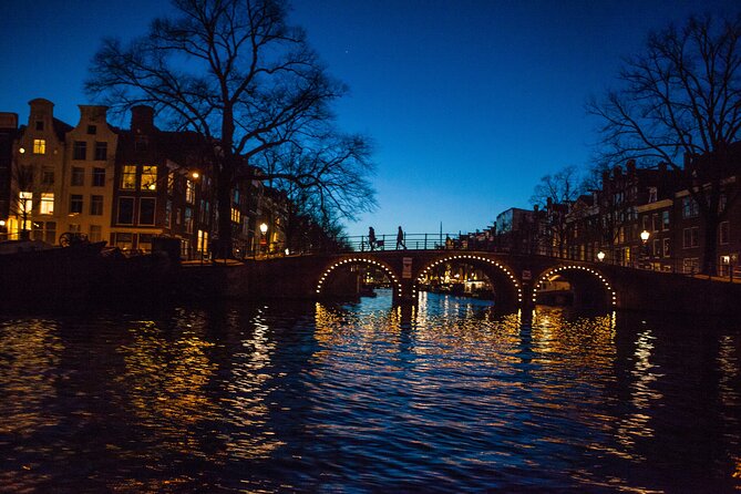 Evening Canal Cruise in Amsterdam with Wine & Cheese Option - Down the Amstel River: Magere Brug, Amstel Hotel, and the icons the narration calls out