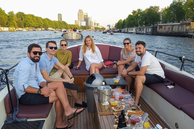 Guided Amsterdam Canal Cruise – Snacks & Drinks on board(1 Hour) - The oldest Amsterdam stretch: narrow streets, leaning houses, and a surprising quiet church