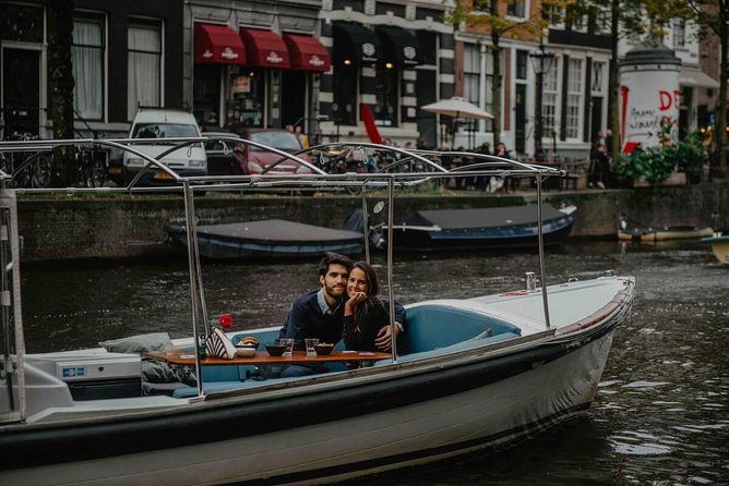 Private Romantic Canal Cruise Amsterdam with Bubbly and Snacks - The Amstel stretches: calmer water, open views, and classic landmarks